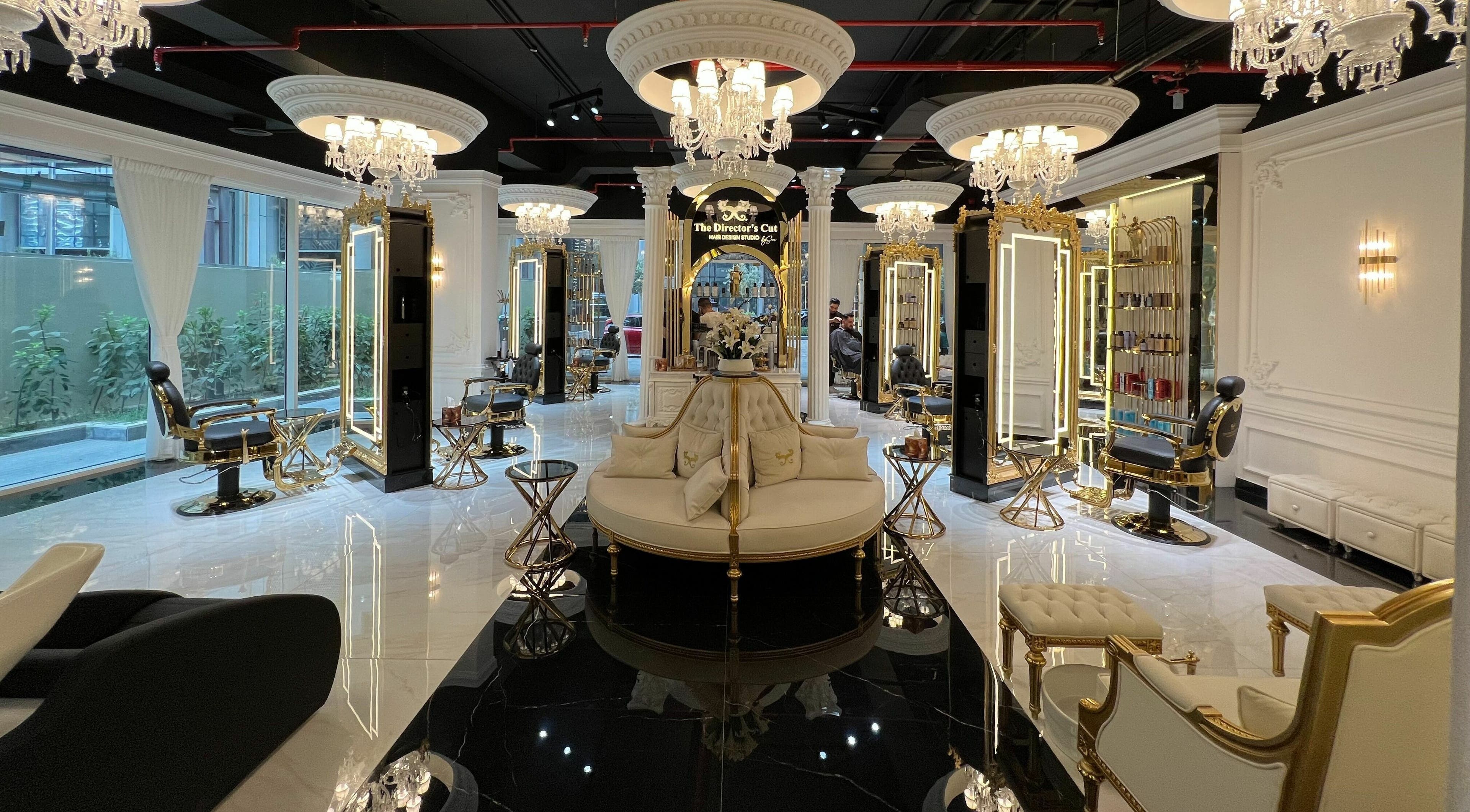 Luxurious interior of The Directors Cut, a beauty salon in Dubai, AE, featuring ornate decor and chandeliers.