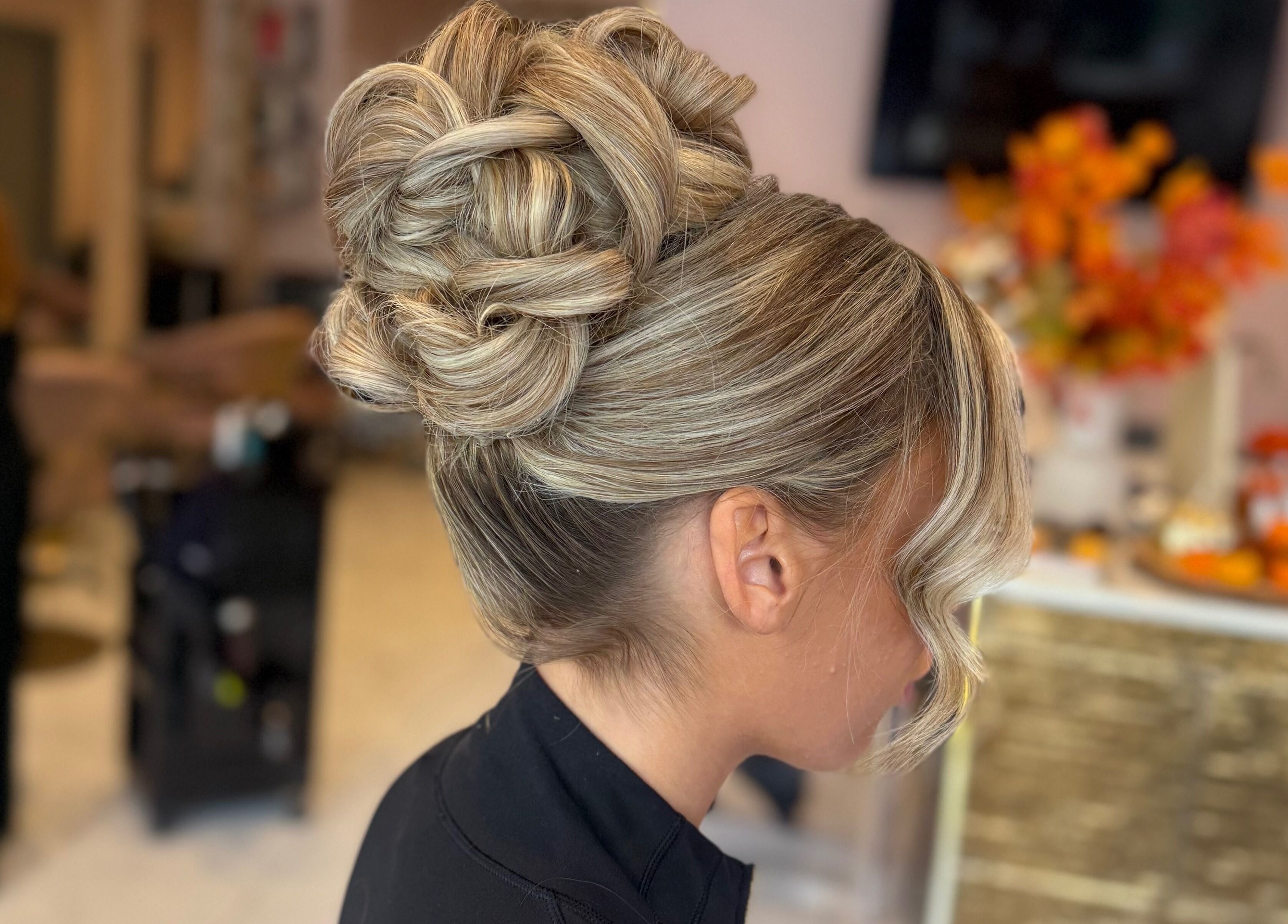 Elegant updo hairstyle at Grip & Curl, Hull, England, GB, showcasing intricate braids and curls.