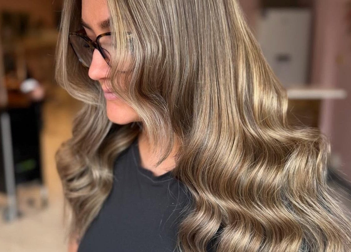 Woman with wavy hair at Grip & Curl, Hull, England, GB, showcasing salon style.