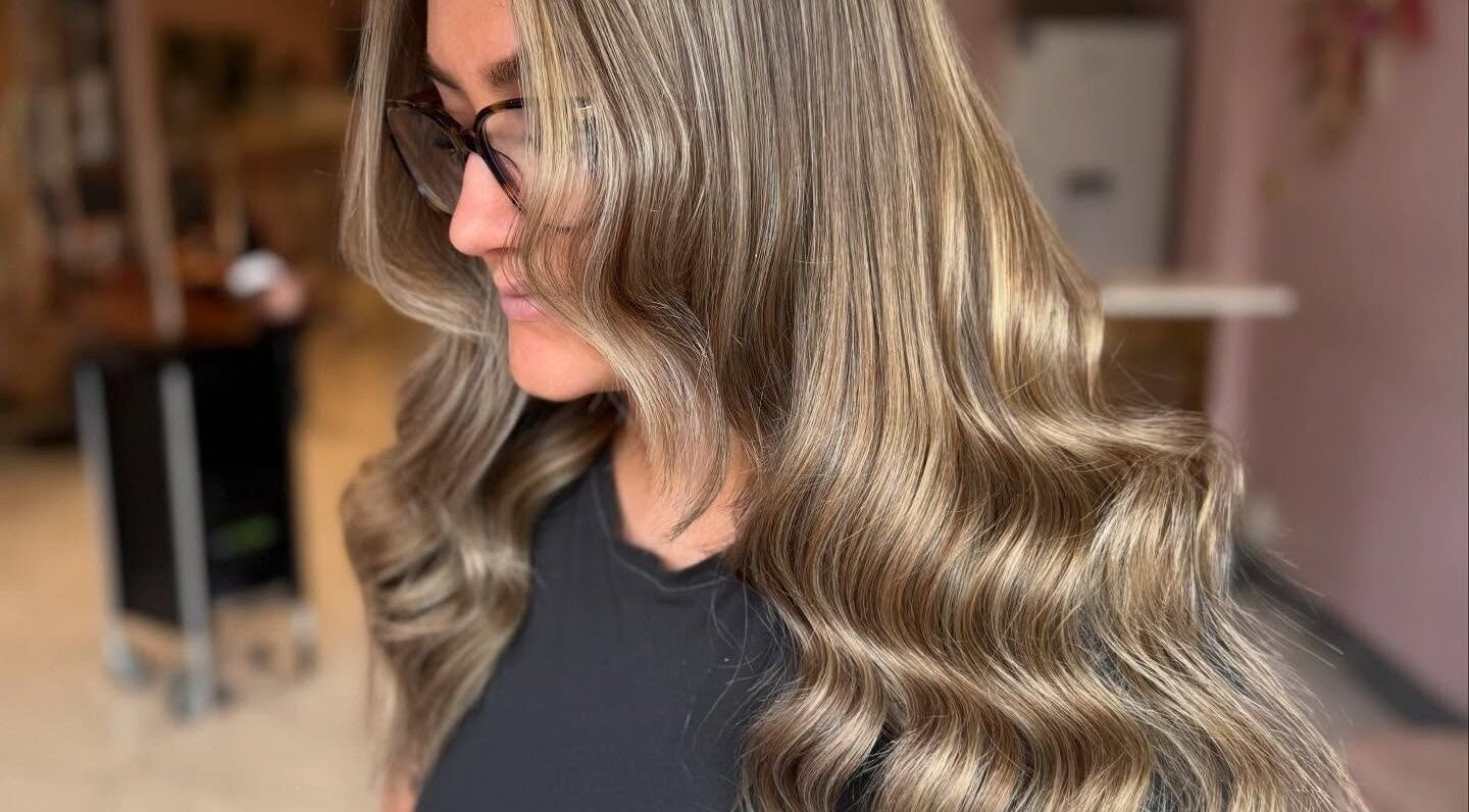 Woman with wavy hair at Grip & Curl, Hull, England, GB, showcasing salon style.