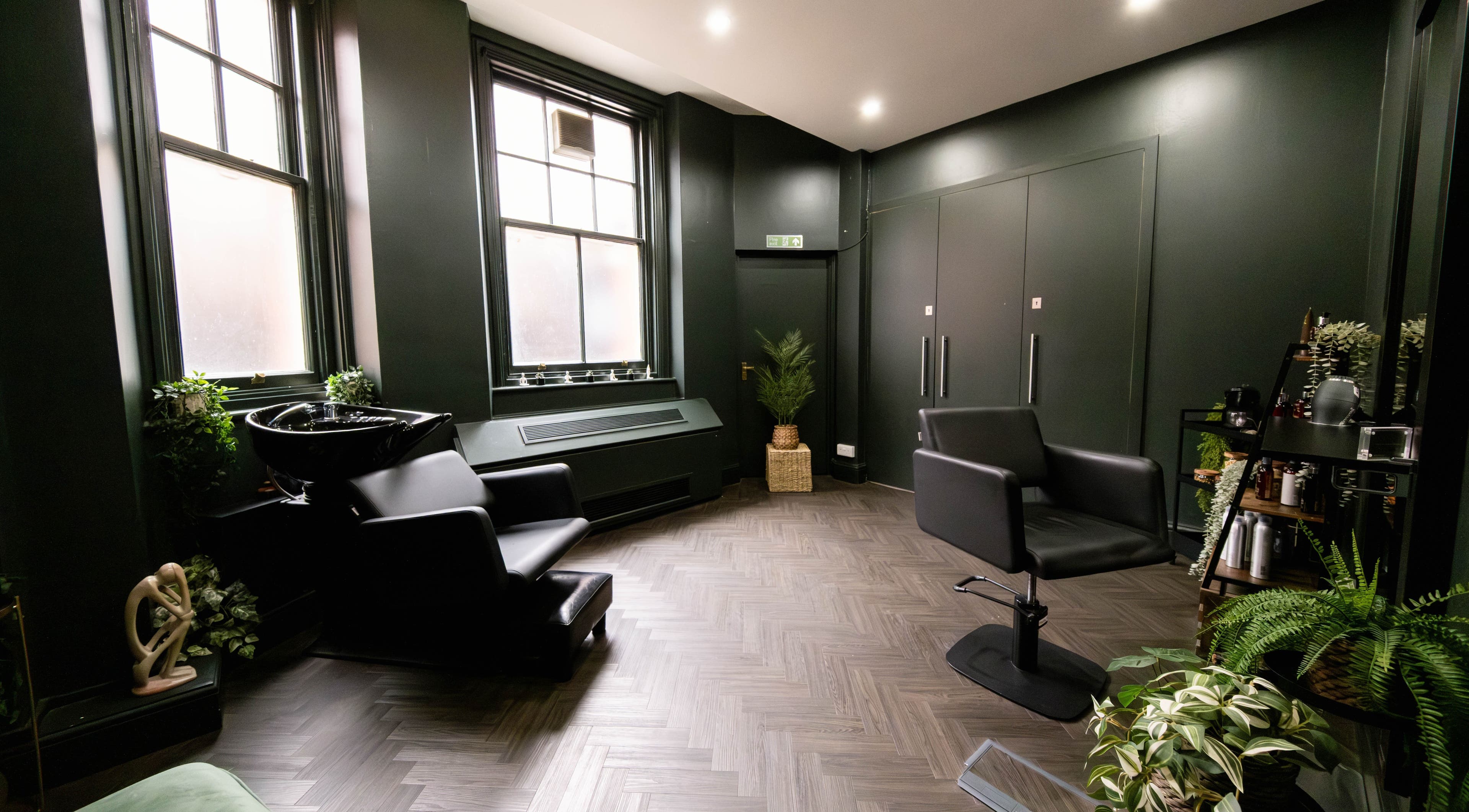 Elegant interior of Jivan Room in London, England, GB featuring modern chairs and lush plants.