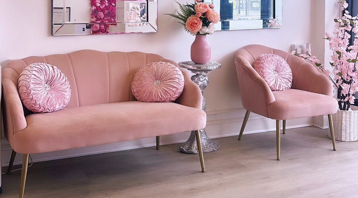Elegant pink seating area at Pretty Woman Beauty Salon in Sutton, England, GB, offering luxurious comfort.