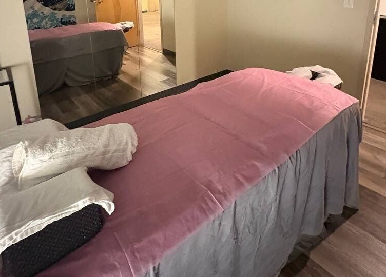 Cozy massage room with pink sheet at Tropical Touch Columbus LLC, Columbus, Ohio, US for ultimate relaxation.