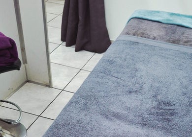 Relaxing spa bed at Madelein Nails and Beauty, Pretoria, Gauteng, ZA, with soft towels in a calming ambiance.