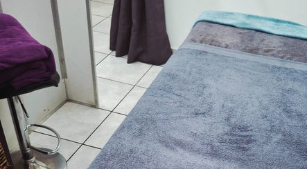 Relaxing spa bed at Madelein Nails and Beauty, Pretoria, Gauteng, ZA, with soft towels in a calming ambiance.