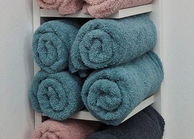 Stacked soft towels at Madelein Nails and Beauty, Pretoria, Gauteng, ZA, promoting comfort and relaxation.