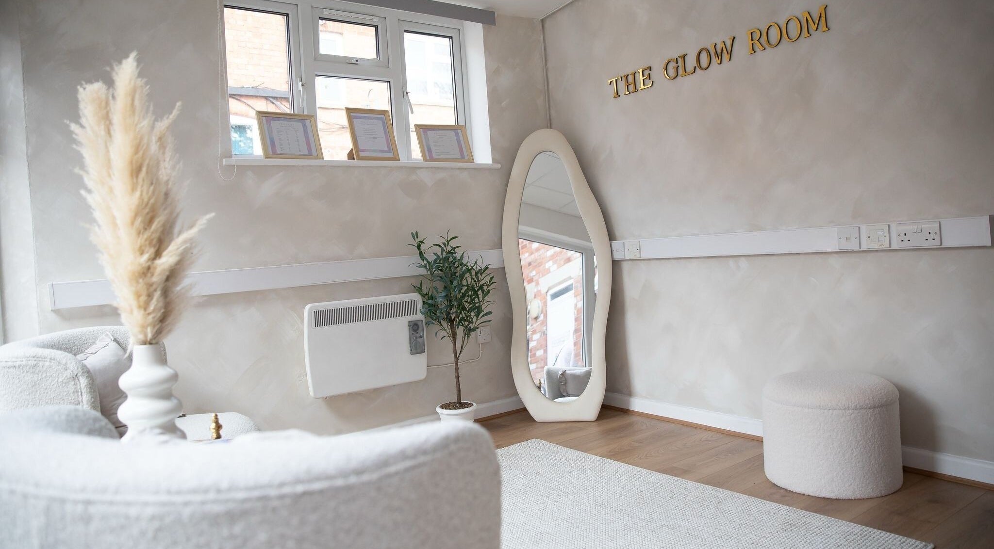 Elegant interior at The Glow Room Brackley, Brackley, England, GB featuring mirror, plant, and stylish decor.