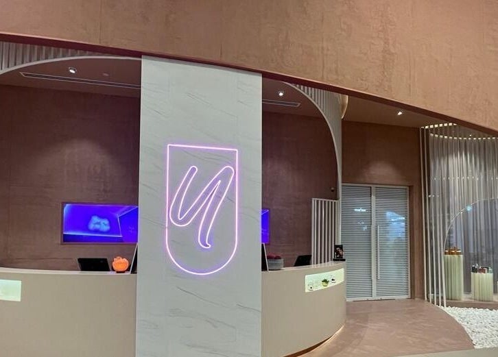 Sleek reception at Yasmin Beauty Lounge, Dubai, Dubai, AE, featuring elegant decor and a neon sign.