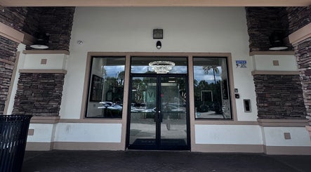 Elegant entrance of StavGhair, featuring a chandelier, located in Parkland, Florida, US.