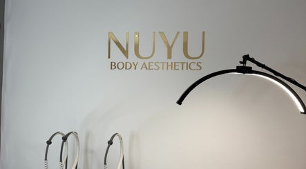 Modern treatment area at NUYU Body Aesthetics, Beckenham, England, GB, showcasing sleek lighting and tools.