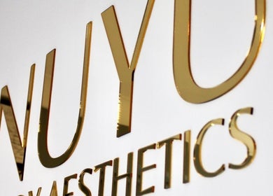 NUYU Body Aesthetics logo in gold at Beckenham, England, GB.