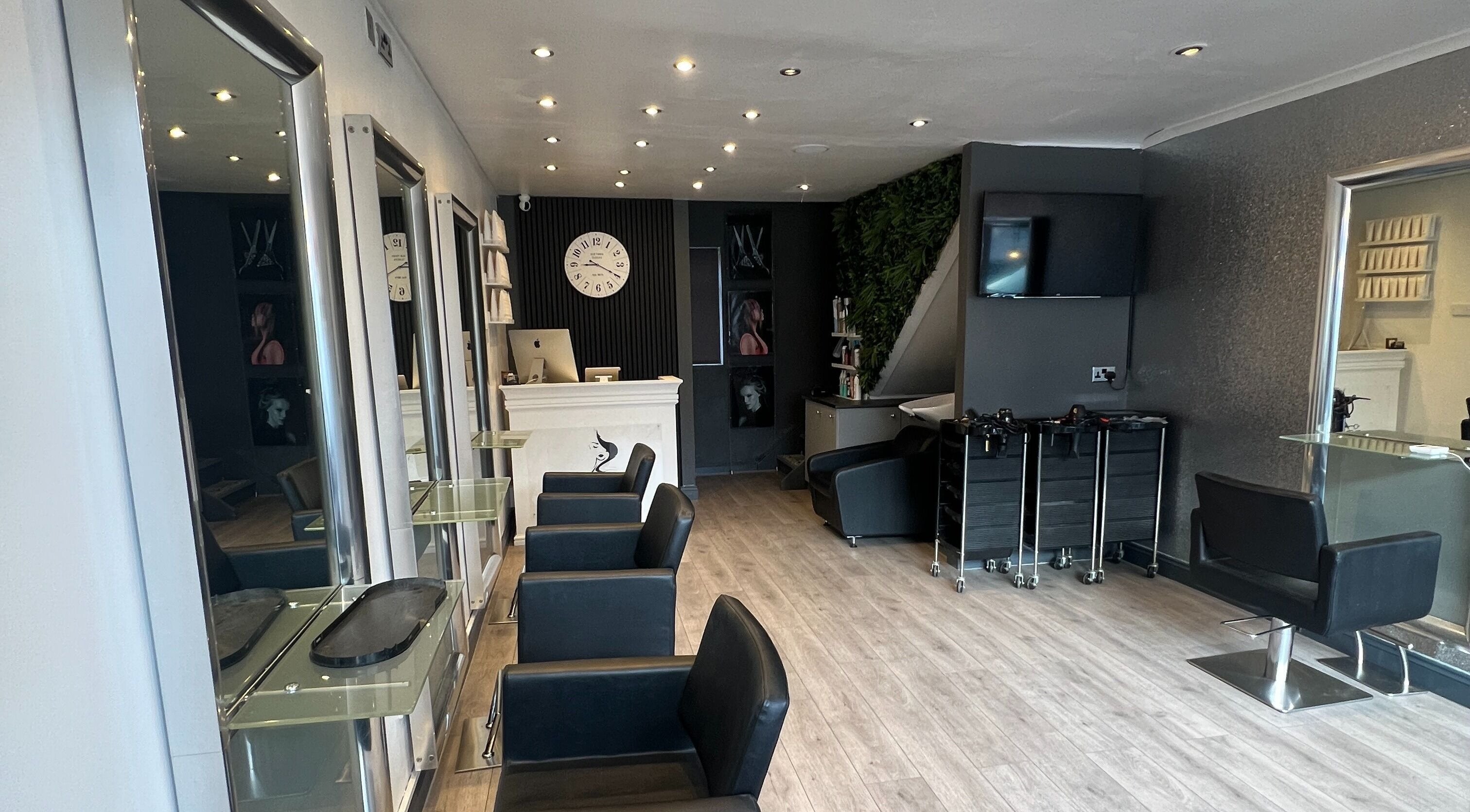 Elegant interior of Florin Bob Hairdressing in Stockport, England, GB with sleek styling stations.