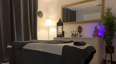 Calm spa room at Florin Bob Hairdressing, Stockport, England, GB. Inviting massage bed and ambient decor.