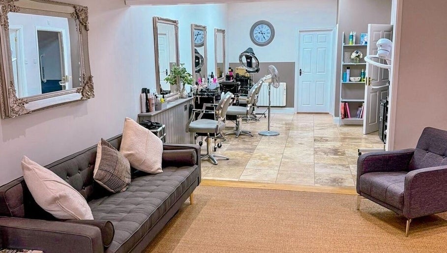 Welcoming interior of Pure Skin & Aesthetics in Hoveton, England, GB with stylish seating and salon chairs.