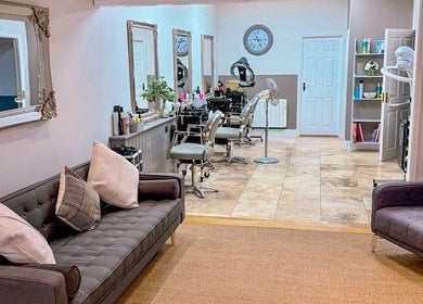 Welcoming interior of Pure Skin & Aesthetics in Hoveton, England, GB with stylish seating and salon chairs.