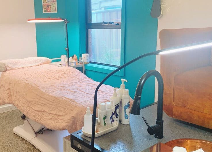 Relaxing treatment room at Peony Beauty Melbourne in Prahran, Victoria, AU with a comfortable bed and soft lighting.