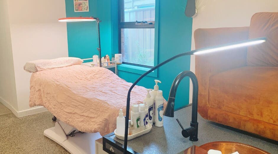 Relaxing treatment room at Peony Beauty Melbourne in Prahran, Victoria, AU with a comfortable bed and soft lighting.