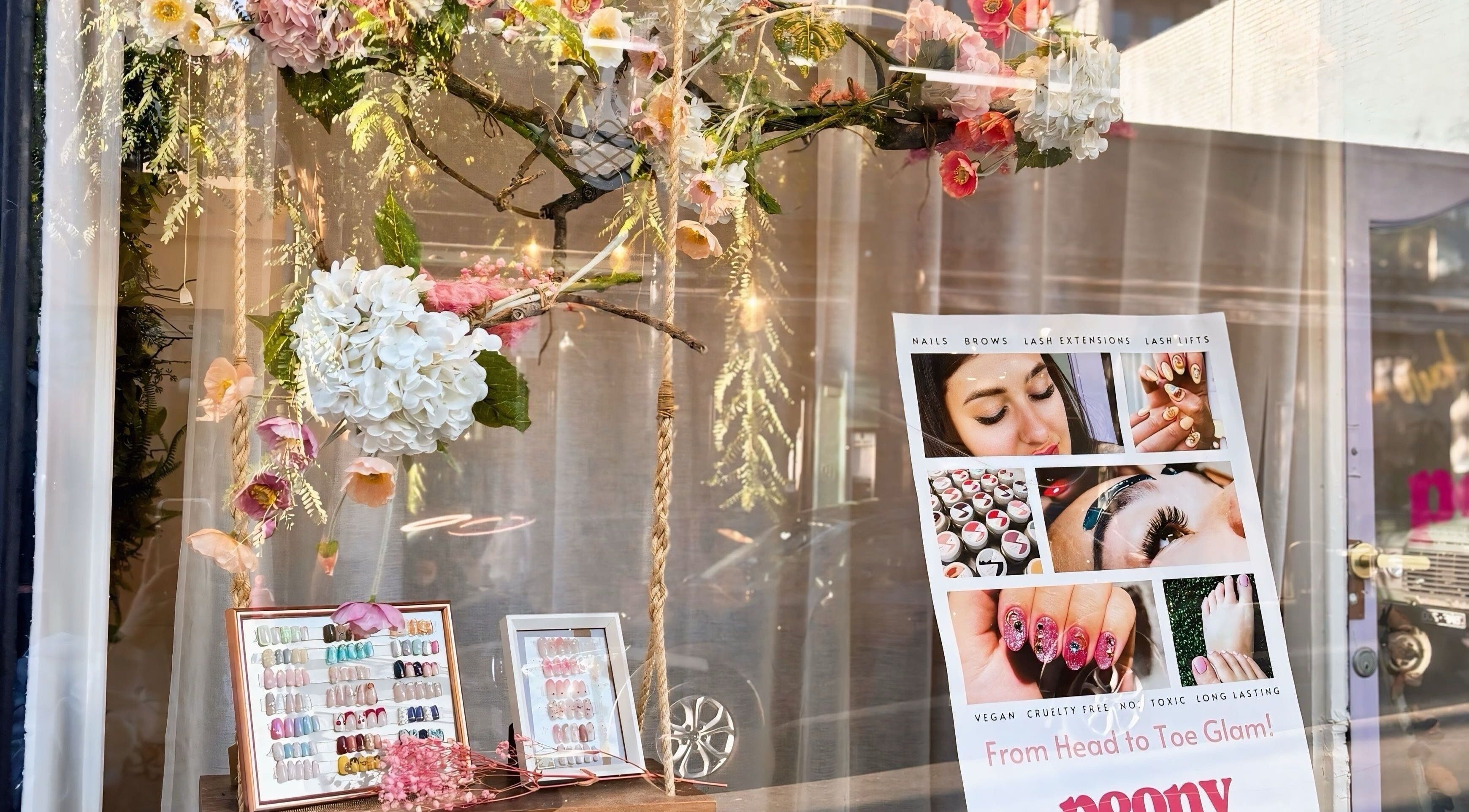 Peony Beauty Melbourne window with floral decor and beauty service poster, Prahran, Victoria, AU.
