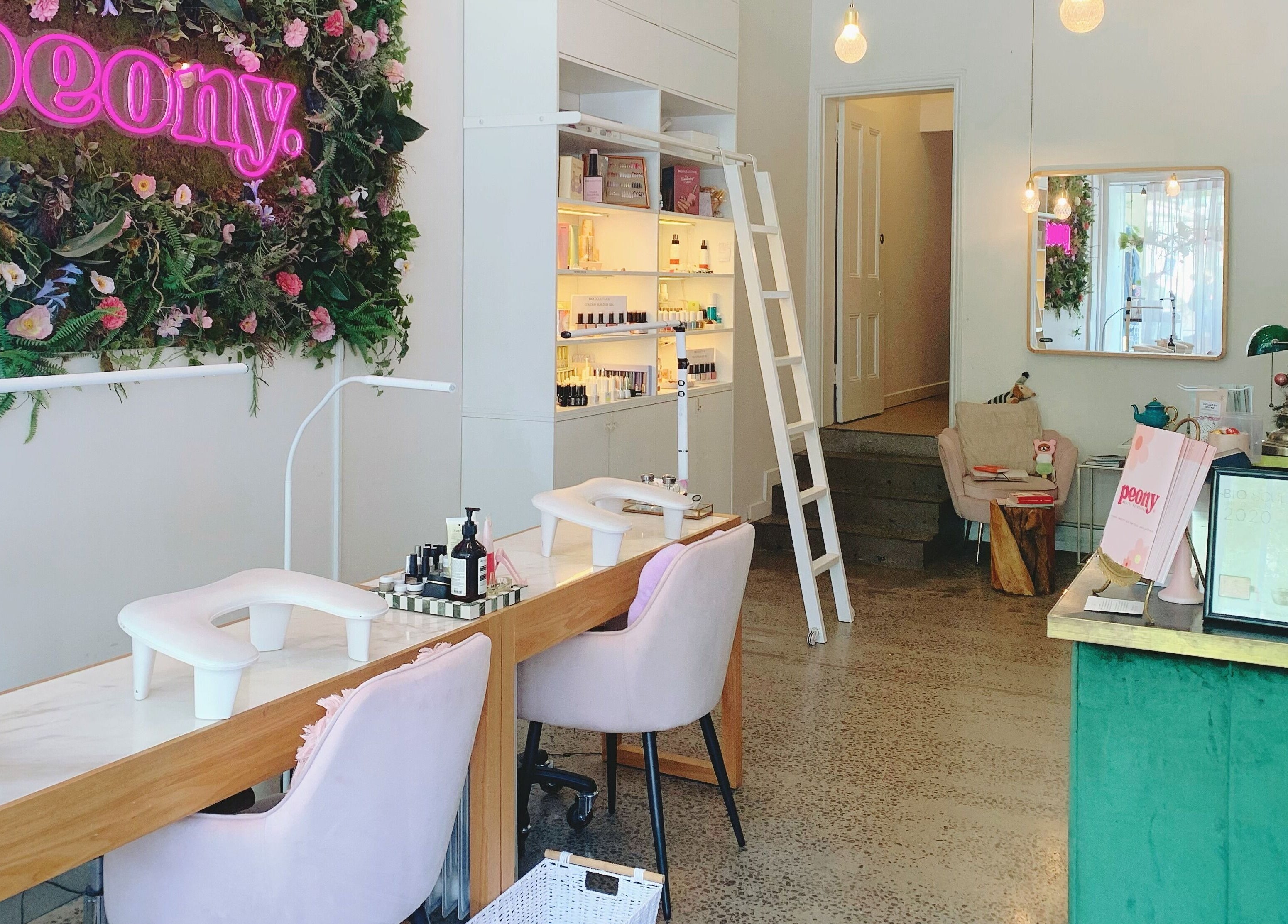 Interior of Peony Beauty Melbourne, Prahran, Victoria, AU. Chic nail stations and lush greenery adorn the space.