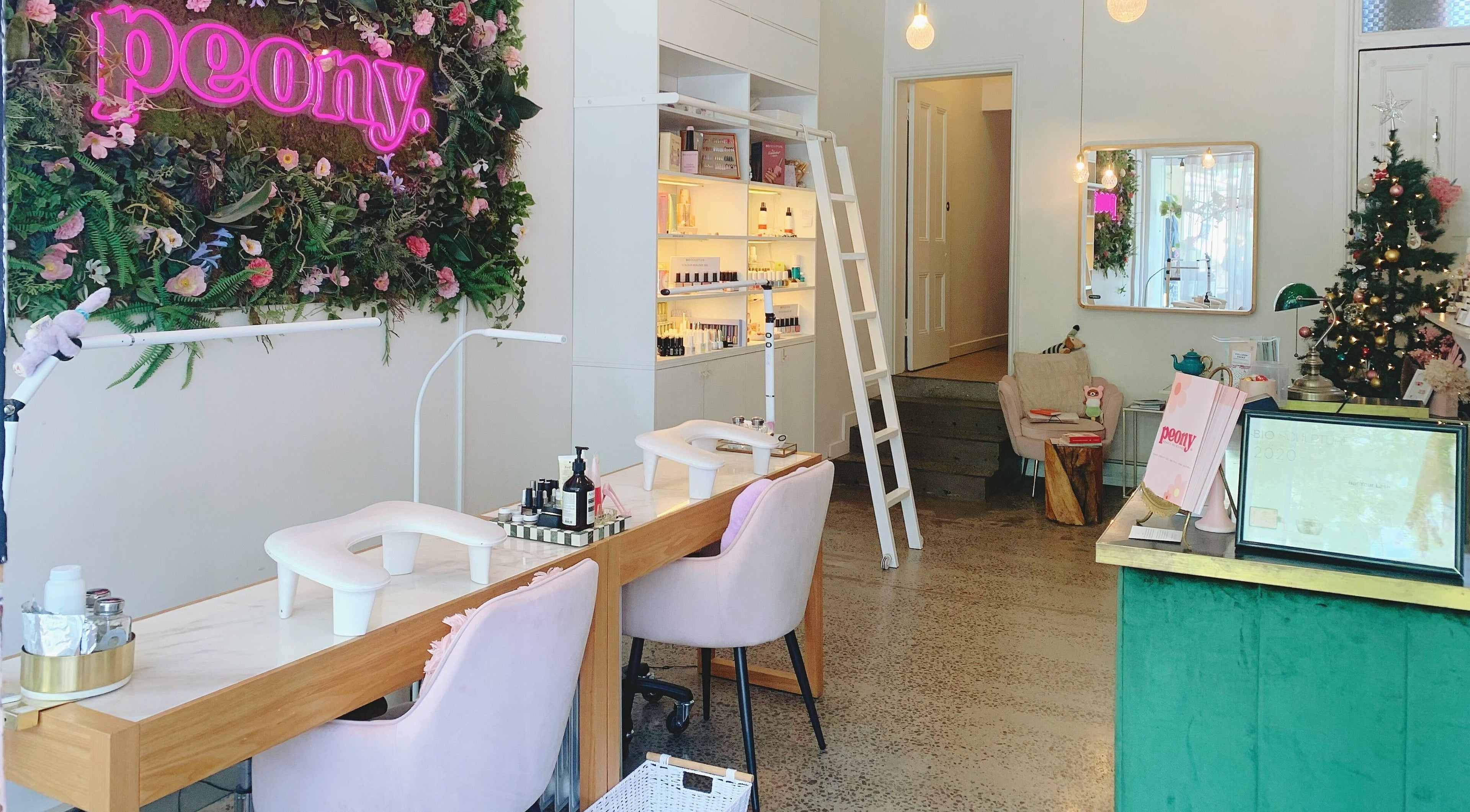 Interior of Peony Beauty Melbourne, Prahran, Victoria, AU. Chic nail stations and lush greenery adorn the space.