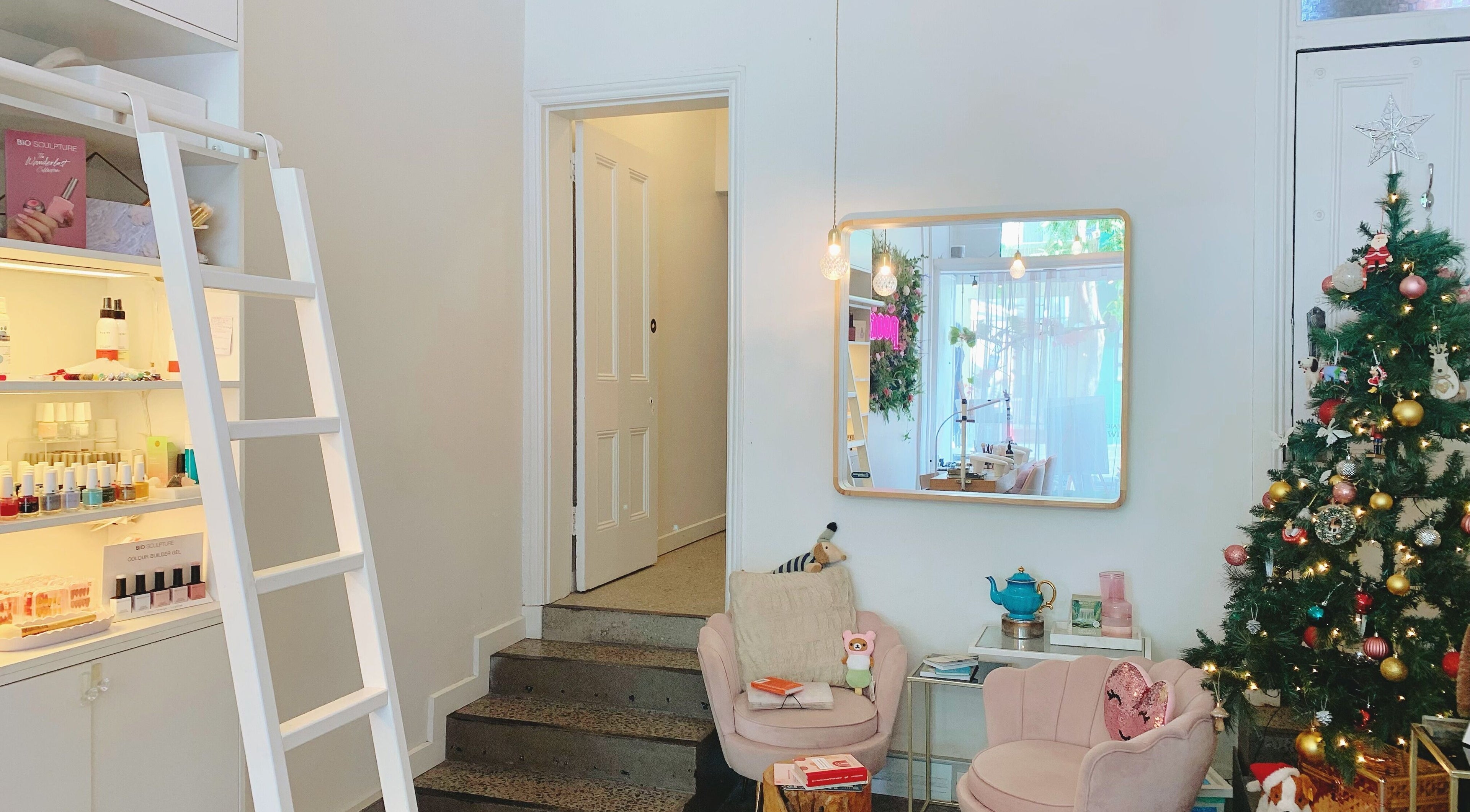 Cozy holiday decor at Peony Beauty Melbourne, Prahran, Victoria, AU features a festive Christmas tree and plush seating.