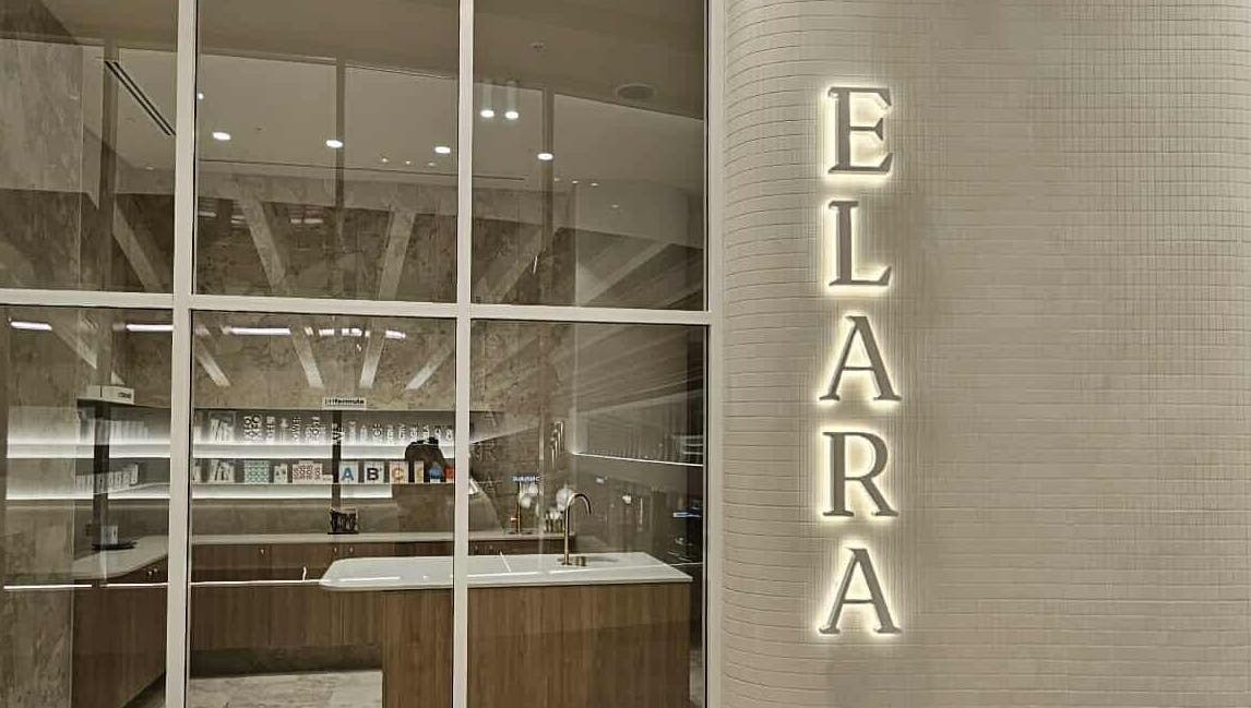 Modern reception area of Elara in Glenside, South Australia with elegant decor and illuminated name sign.