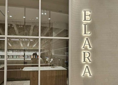 Modern reception area of Elara in Glenside, South Australia with elegant decor and illuminated name sign.
