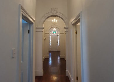 Elegant hallway at The Gym, Mile End, South Australia, AU, featuring white walls and wooden floor.