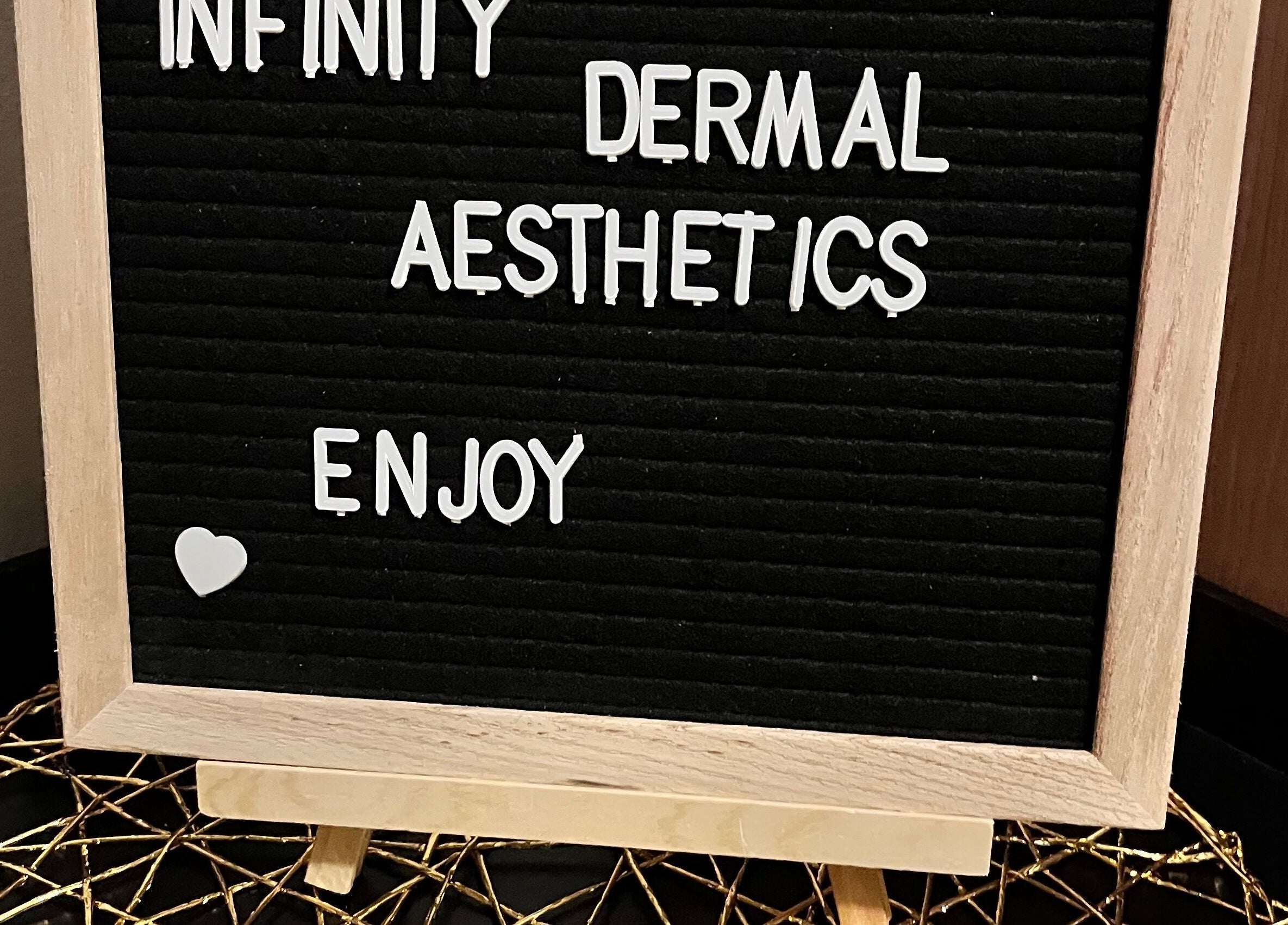 Welcome sign for Infinity Dermal Aesthetics in Johannesburg, Gauteng, ZA, emphasizing enjoyment and care.