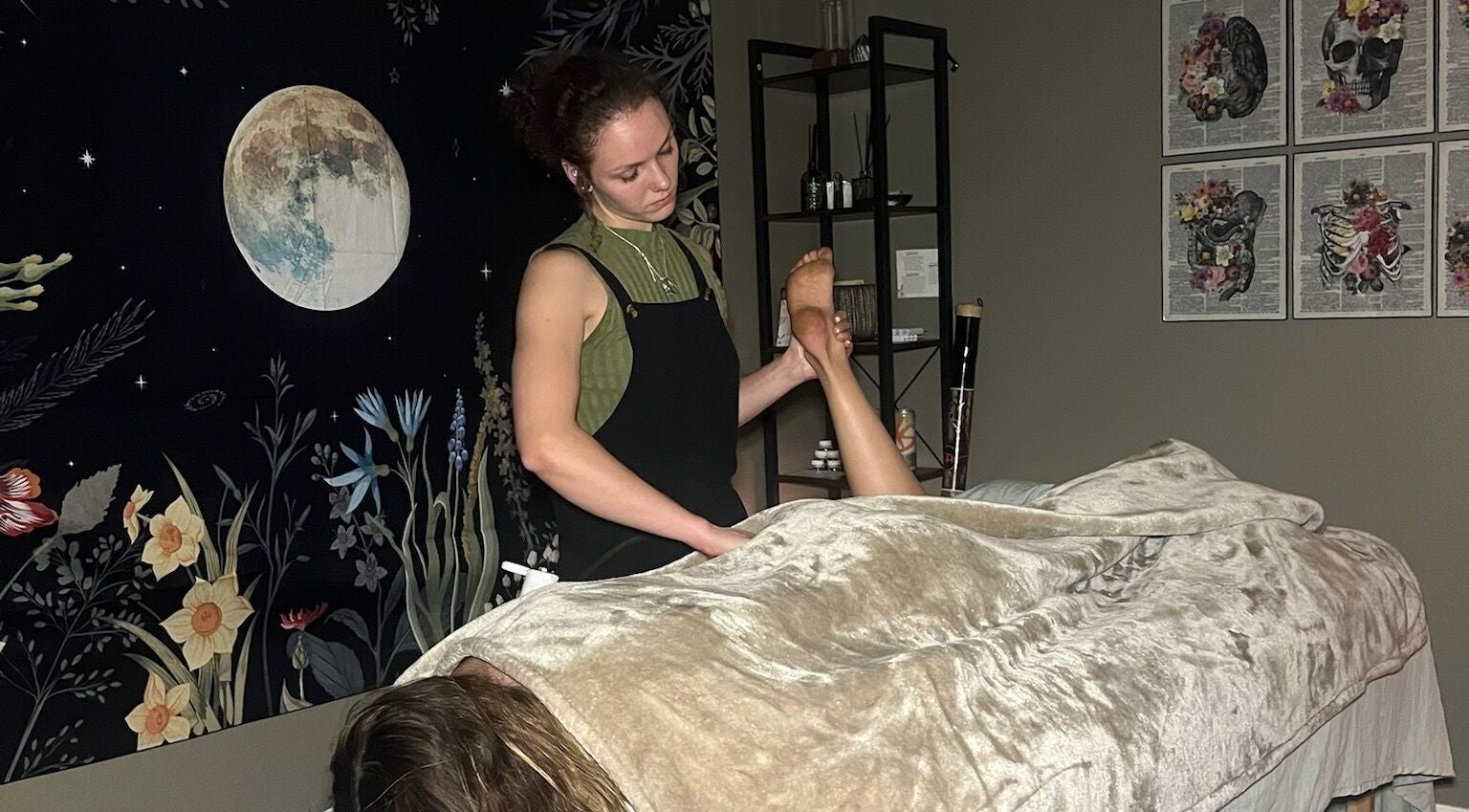 Foot massage session at Blissful Balance in Orem, Utah, US, enhancing relaxation under a calming moonlit tapestry.