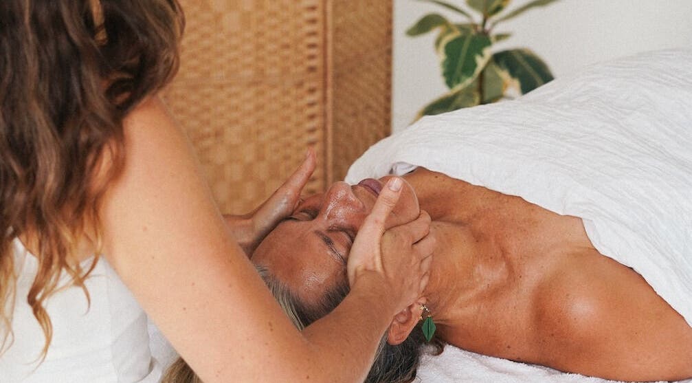 Therapist performing a calming facial massage at Of The Earth - Osteo Hub Mumbles (Tuesdays), Mumbles, Wales, GB.