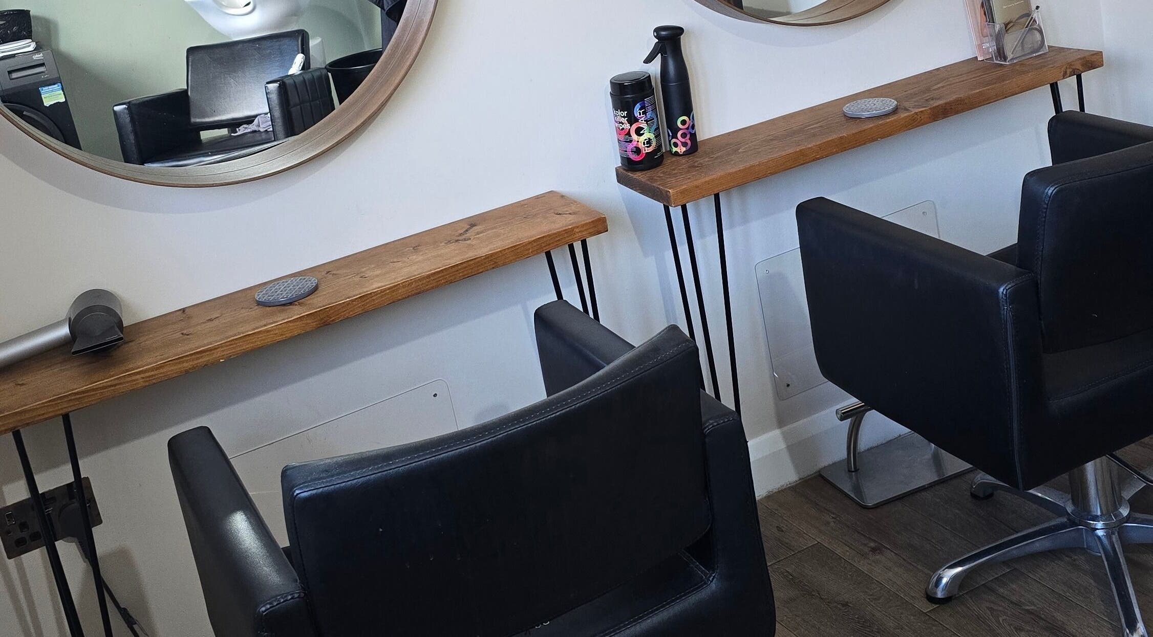 Chic styling chairs and mirrors at The Hair Room in Farnham Royal, England, GB offering a modern salon experience.