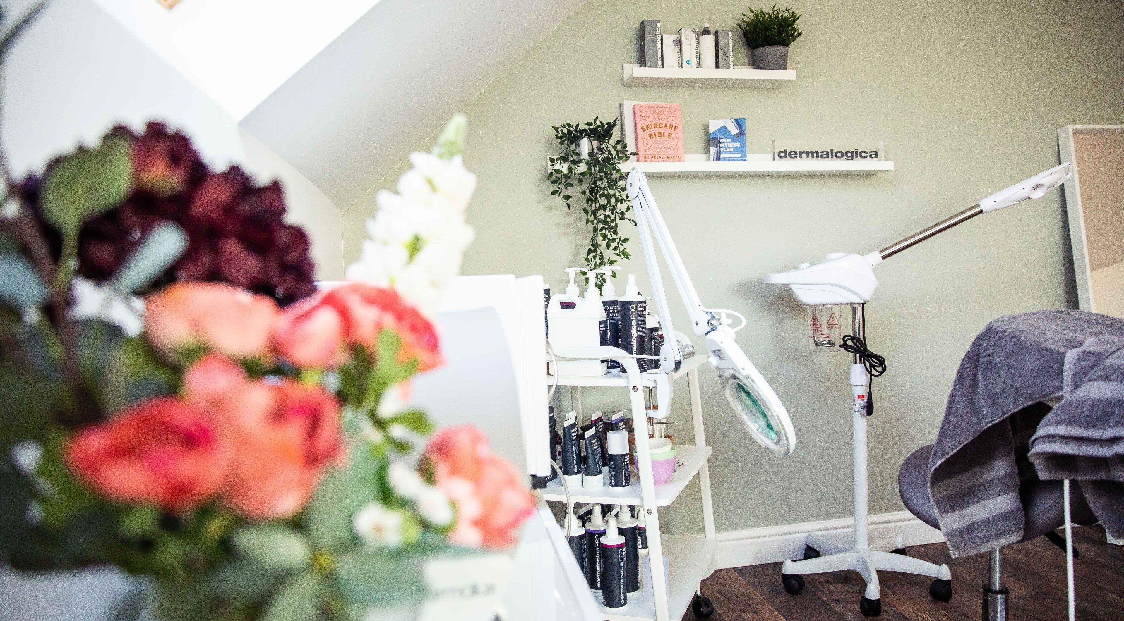 Calming treatment area at Skin Balance Chelmsford, Chelmsford, England, GB, with flowers and skincare products.