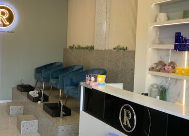 Interior of Rosewood Beauty in Centurion, Gauteng showcasing plush seating and skincare products.
