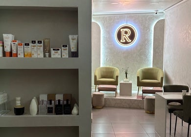 Elegant lounge at Rosewood Beauty, Centurion, Gauteng, ZA with products and soft seating under neon light.