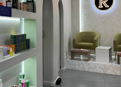 Relaxing lounge at Rosewood Beauty, Centurion, Gauteng, ZA with stylish chairs and shelves of skincare products.