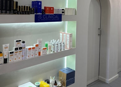 Product display at Rosewood Beauty, Centurion, Gauteng, ZA showcasing premium skincare items on lit shelves.