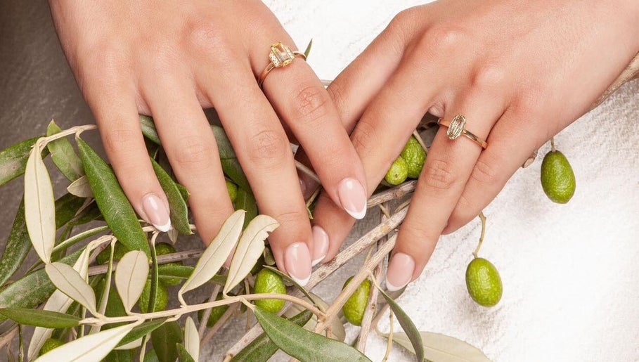 Elegant manicure on hands with rings at Beauty By Ella, Tamworth, England, GB, featuring olive branch.
