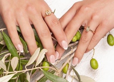 Elegant manicure on hands with rings at Beauty By Ella, Tamworth, England, GB, featuring olive branch.