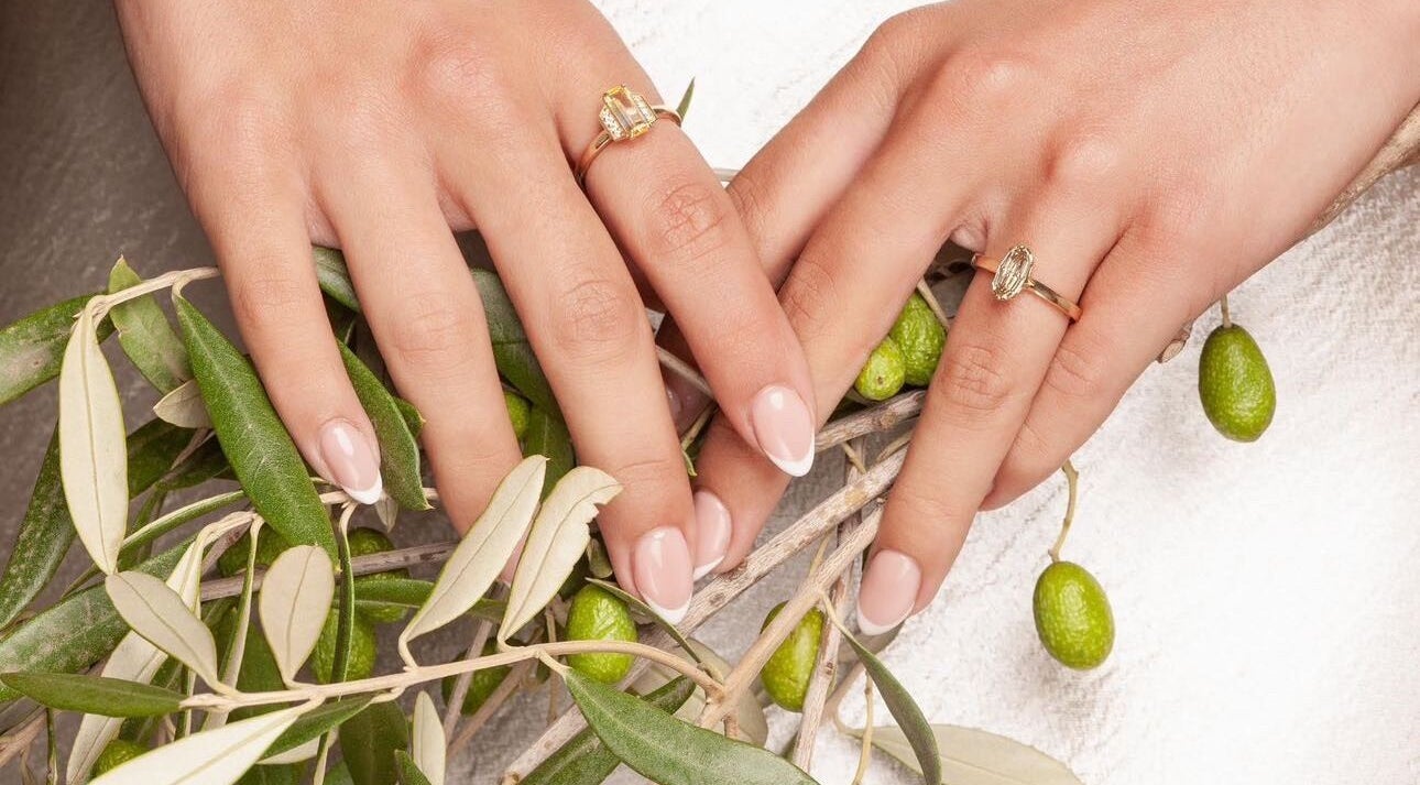 Elegant manicure on hands with rings at Beauty By Ella, Tamworth, England, GB, featuring olive branch.