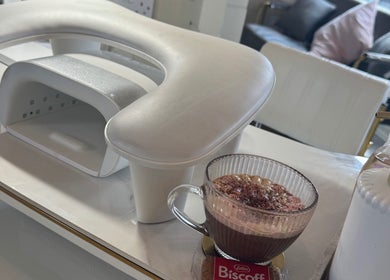 Nail station at Beauty By Ella, Tamworth, England with a cozy drink and Biscoff biscuit.