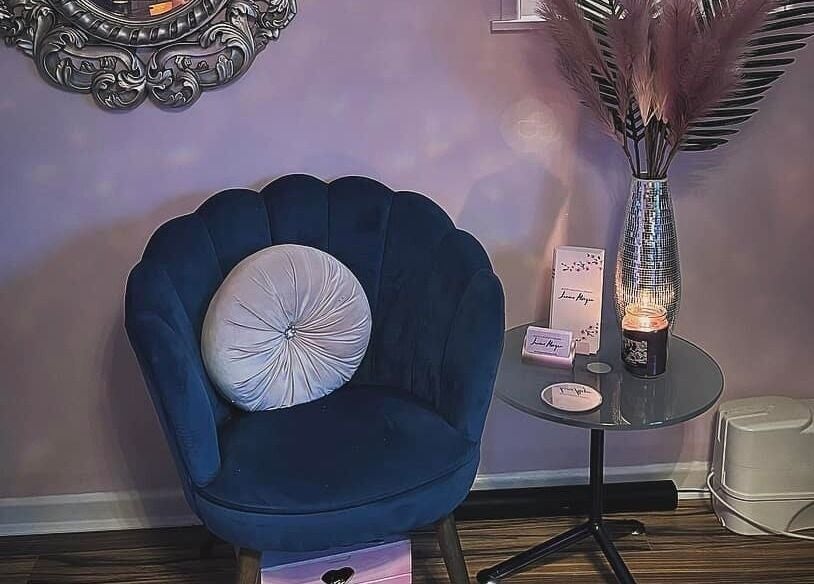 Elegant seating area at Janine Morgan, Lytham St Annes, England, GB, featuring a plush chair and decor.