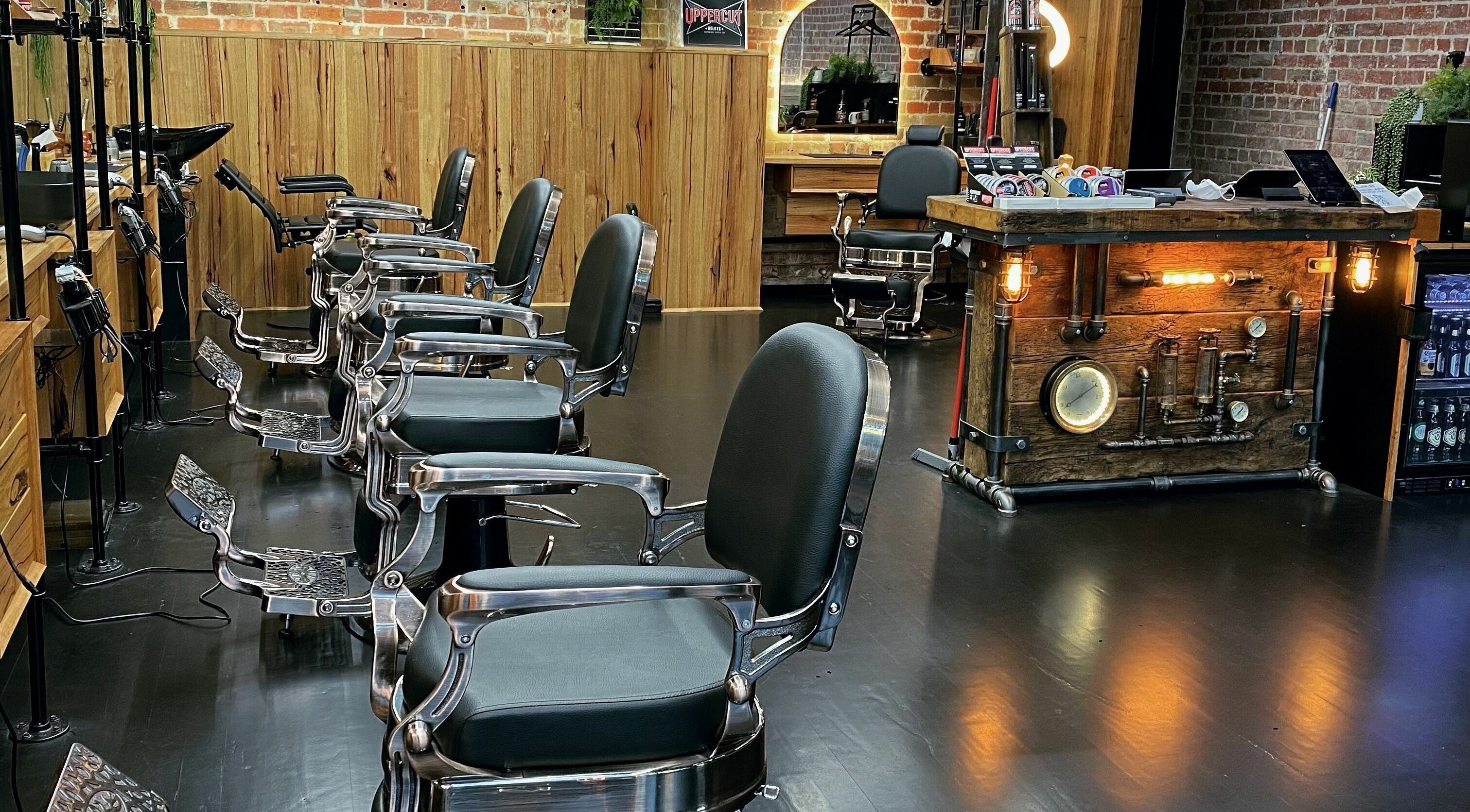 Chic interior of Cutthroat Barber Co. in Melbourne, Victoria, AU featuring vintage barber chairs and rustic decor.