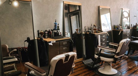 Modern barber setup at Top End Barber in Melbourne, Victoria, AU featuring sleek barber chairs and mirrors.