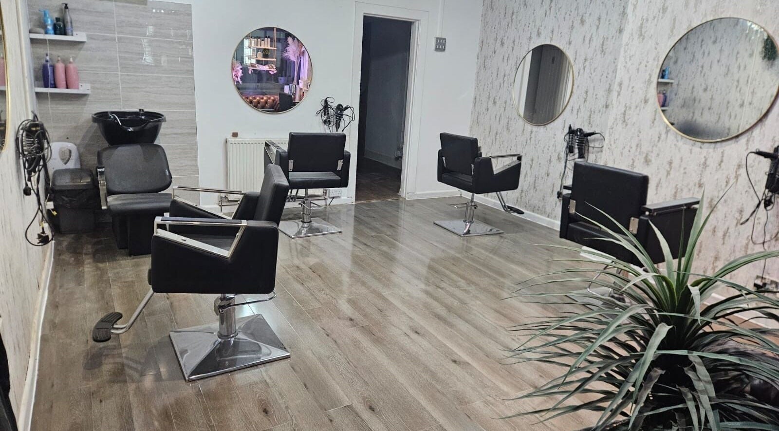 Modern salon chairs and mirrors at Leah - Marie Hair and Beauty in Hindley, England, GB.