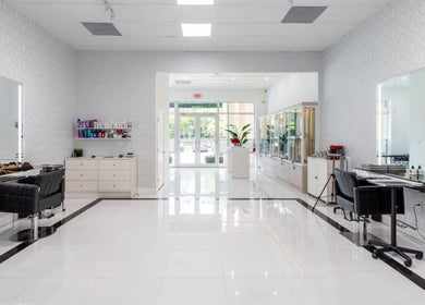 Modern salon interior of Beauty Locks Hair Extensions, North Miami Beach, Florida, US, with chairs and mirrors.