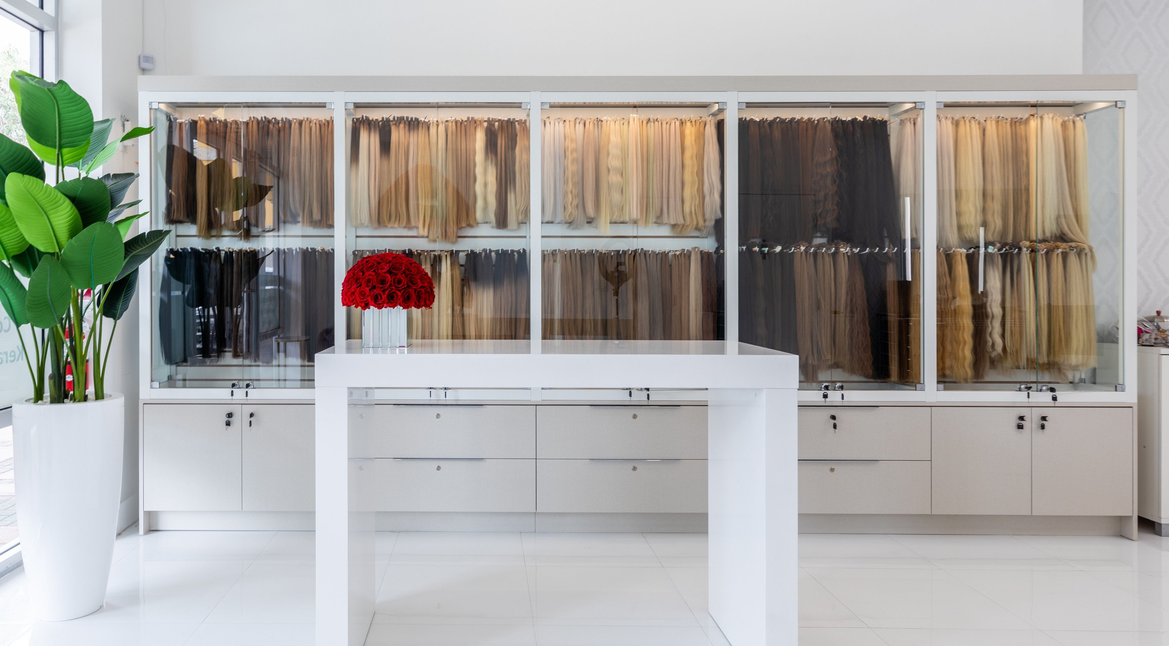 Hair extensions display at Beauty Locks Hair Extensions, North Miami Beach, Florida, US with red roses centerpiece.