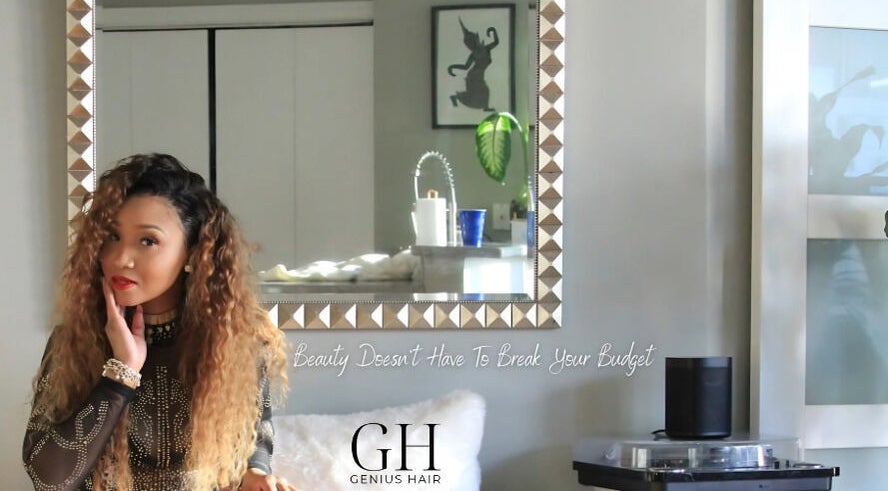 Elegant woman in Genius Hair Collection LLC, College Park GA showcases beauty and style in a mirrored setting.