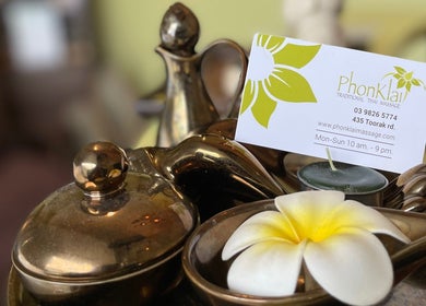 PhonKlai Thai Massage Toorak business card on a serene bronze tray in Melbourne, Victoria, AU.