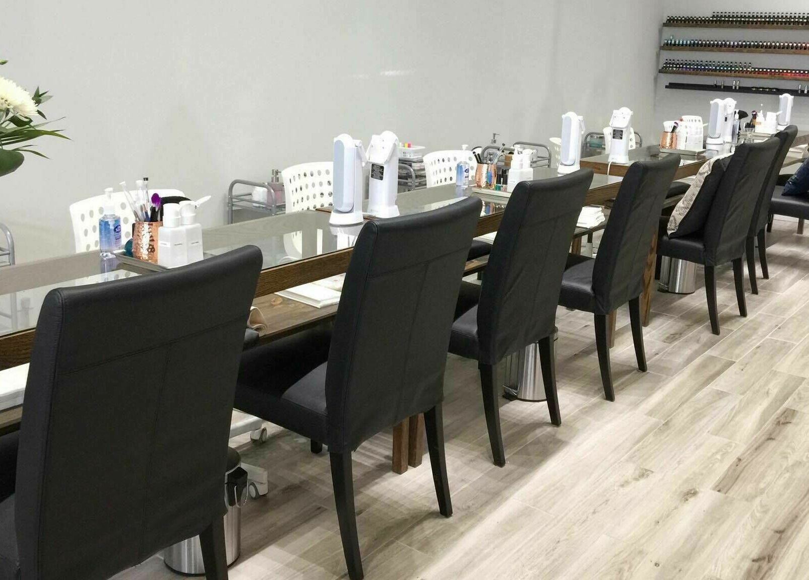 Chic manicure stations at Luna Nails and Spa, Ottawa, Ontario, CA, with flowers and modern decor.